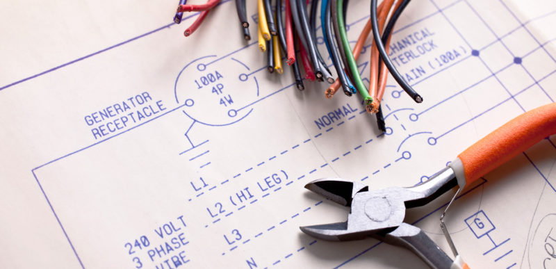 Electrical Wiring with wire cutters and blueprints